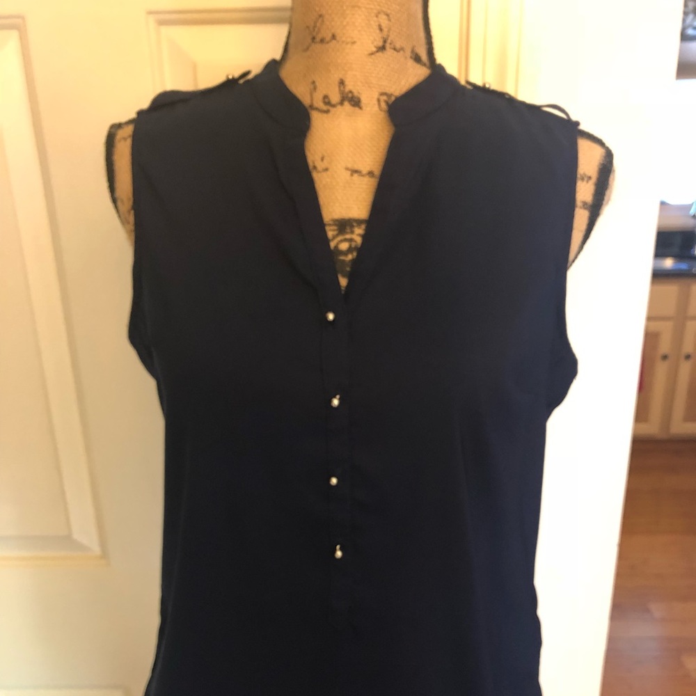 Sleeveless navy blue, shirt with silver details.